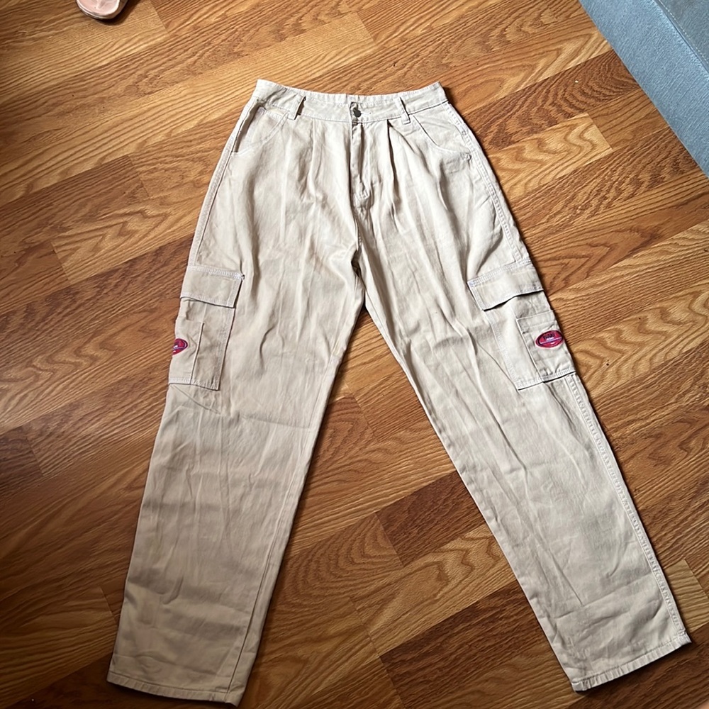The pants are tan, they are loose on the legs, the fabric is super good